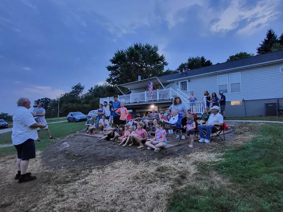 The church family gathered in a backyard on a summer evening